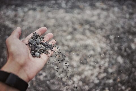 Hand holding sand and gravel