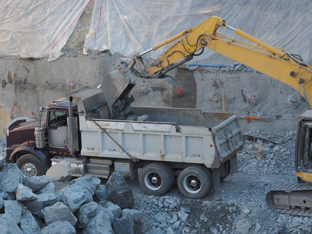 Dump Truck Hauling Heavy Equipment in Baltimore